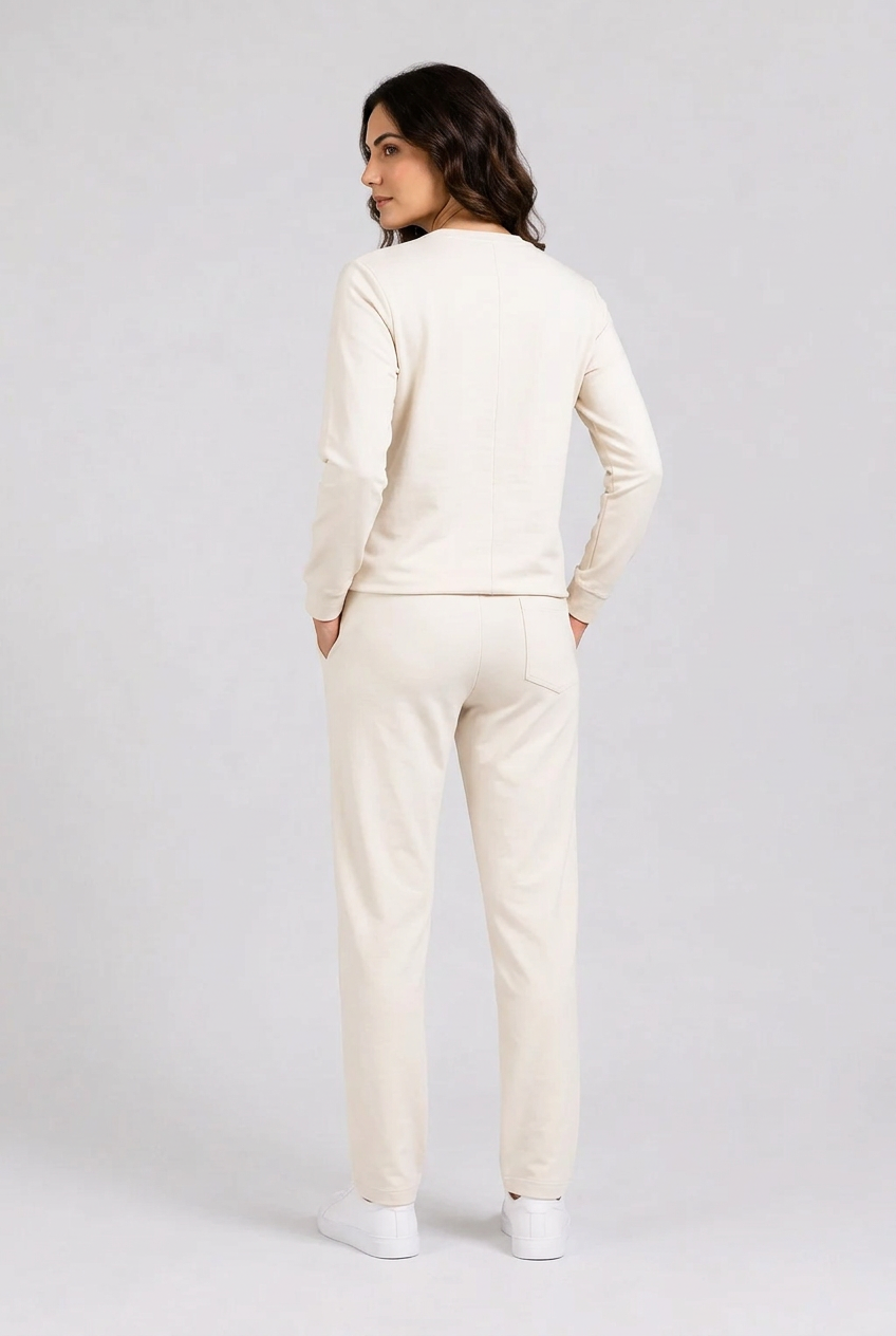 Woman wearing cream tracksuit back view