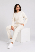Woman wearing cream tracksuit seated