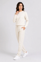 Woman wearing cream tracksuit walking pose