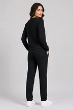 Woman wearing plain black tracksuit back view