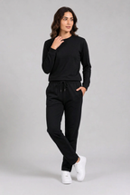 Woman wearing plain black tracksuit relaxed standing pose
